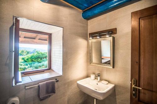 a bathroom with a sink and a mirror and a window at Villa Stargazer in Kozljak