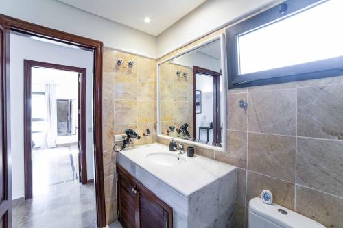 łazienka z umywalką i lustrem w obiekcie Villa Lucero w mieście Playa Blanca