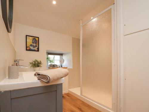 a bathroom with a shower and a sink at Rose Cottage in Settle