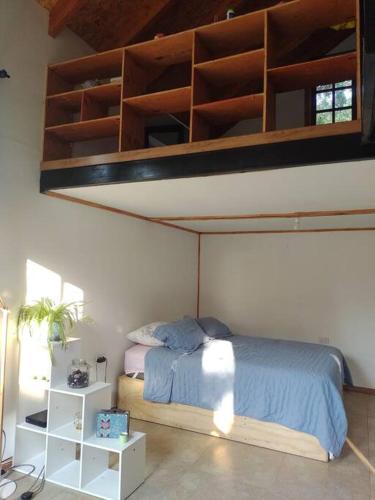 a bedroom with a bunk bed with blue sheets at Cabaña de campo en Pirque in Pirque