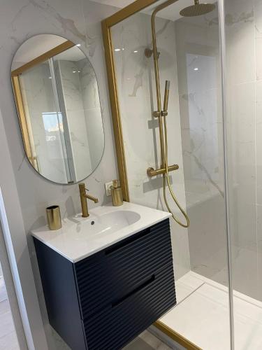a bathroom with a sink and a shower with a mirror at Apartamento Tres Banderas in Estepona
