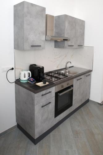 a kitchen with a stove and a sink at Villa Albaluce in Caluso