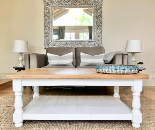 a living room with a couch and a mirror at Coastal Chic waterfront studio in Kinsale