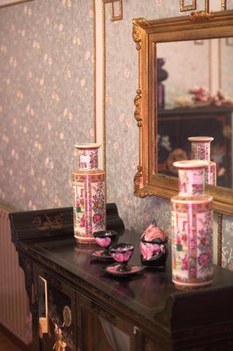 a table with three vases on top of it at Villa Albaluce in Caluso