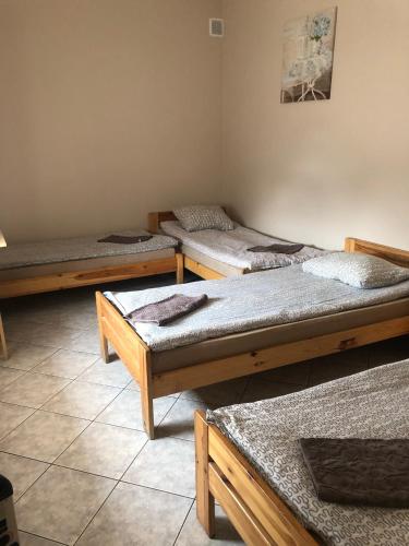 a room with three beds in a room at Piątka noclegi- Łódź in Łódź