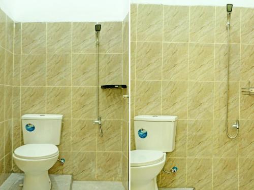 a bathroom with a toilet and a shower stall at OYO 92293 Pahala Syariah Residence in Prabumulih