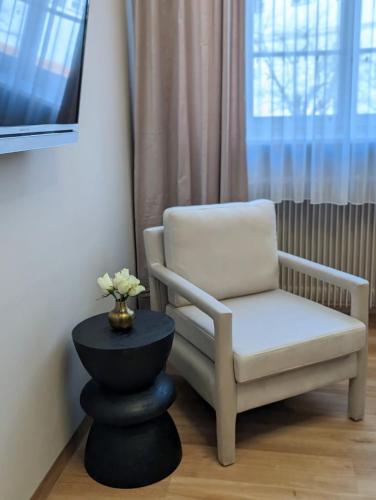 a chair sitting next to a window in a room at Hotel Martin am Dom in Bamberg