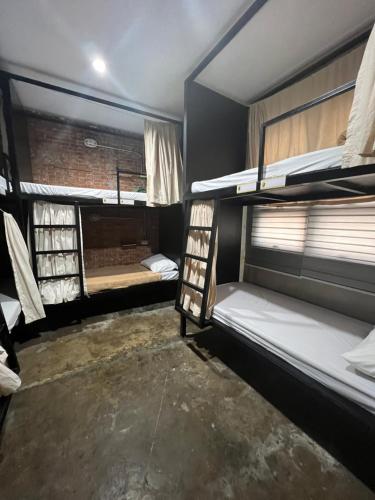 a room with two bunk beds and a window at HappyNest Hostel Cebu in Cebu City