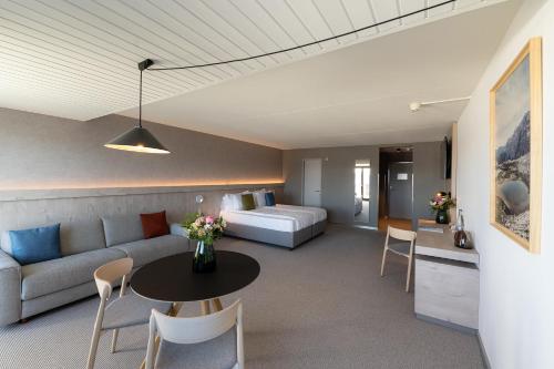 a living room with a couch and a table at Victoria Hotel & Residence in Villars-sur-Ollon