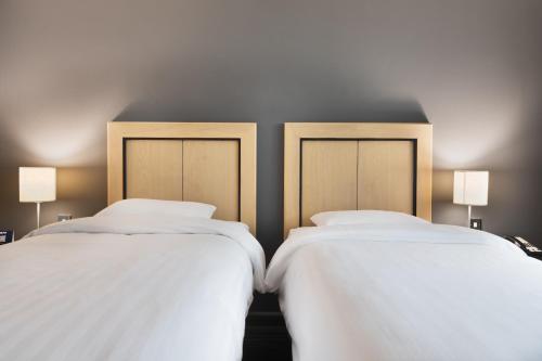 two beds sitting next to each other in a room at Park Inn by Radisson Cardiff City Centre in Cardiff