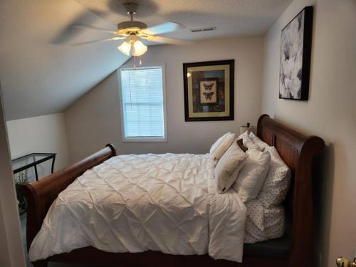 a bedroom with a bed with a ceiling fan at 8. Beautiful secluded creek front lodge in Guntersville