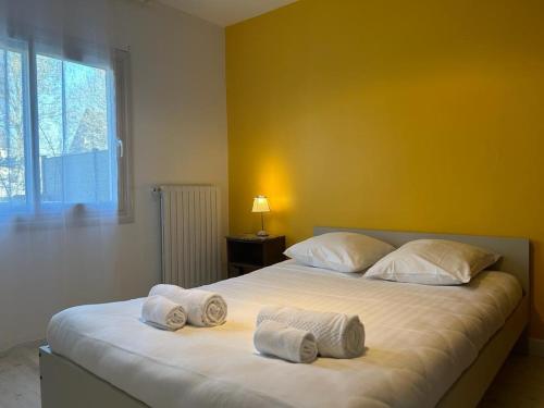 1 dormitorio con 1 cama grande y toallas. en L'escapade - Maison familiale avec jardin Vannes, en Vannes