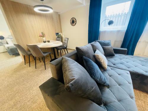 a living room with a couch and a table at Alanta Apartments Easy Kaunas in Kaunas