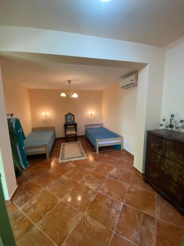 a living room with two beds and a tiled floor at Maroccana in Dobra Voda