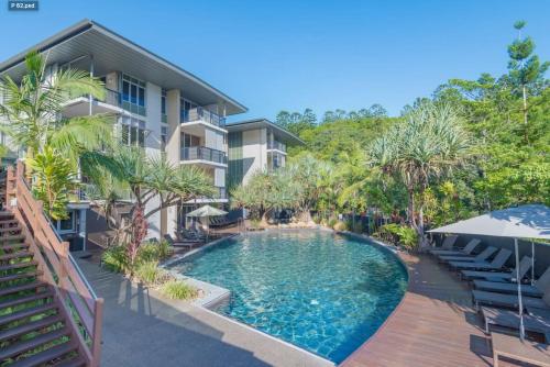 a swimming pool in front of a building at 9408 Luxury Apartment Close to Hastings Street in Noosa Heads