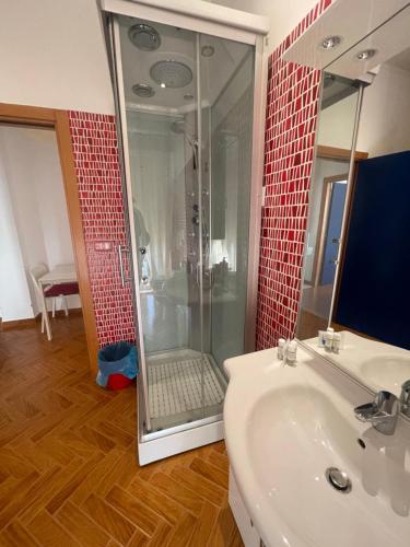 a bathroom with a glass shower and a sink at Casina Dei Marsi in Avezzano