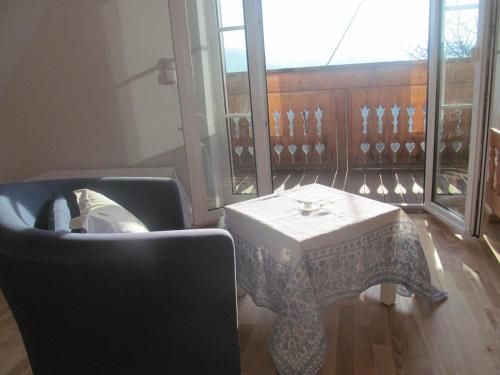 a living room with a table and a couch and a window at Holiday Home Sonnenhaus in Svečina