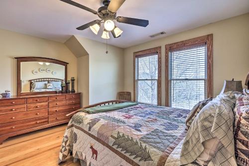 a bedroom with a bed and a dresser and a mirror at Lake Wedowee Vacation Rental with Hot Tub in Wedowee