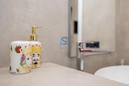 a bottle of disinfectant sitting on a counter in a bathroom at Al Posto Giusto - Self Check in in Cefalù
