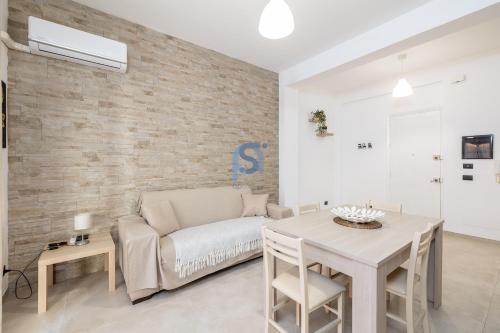 a living room with a couch and a table at Al Posto Giusto - Self Check in in Cefalù