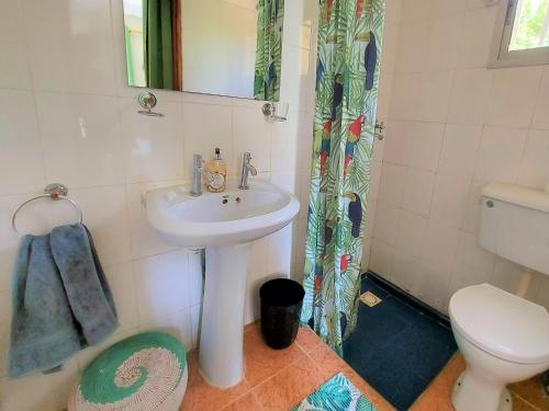 a bathroom with a sink and a toilet at Bougainvillea House in Bijilo