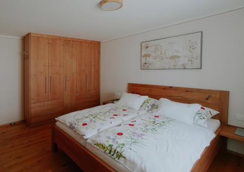 a bedroom with a bed with a wooden headboard at Mühlbauerhof in Großklein