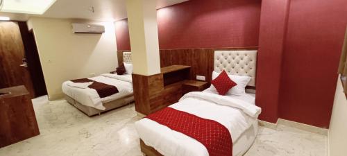 a hotel room with two beds in a room at Mayda Inn- A Boutique Hotel in New Delhi