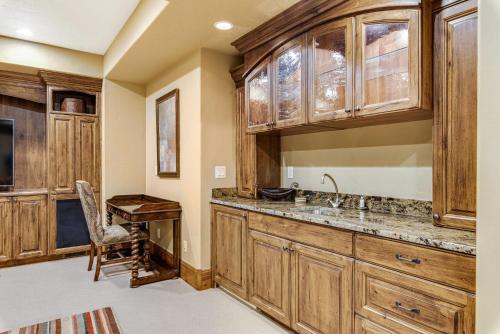 uma cozinha com armários de madeira e uma secretária de madeira em Gorgeous Deer Valley mountain home minutes from the slopes em Park City