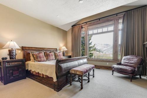 a bedroom with a bed and a chair and a window at Gorgeous Deer Valley mountain home minutes from the slopes in Park City