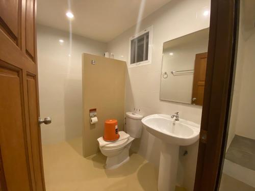 a bathroom with a toilet and a sink at Malee Sirin Old Town in Ko Lanta