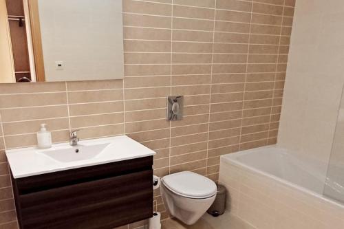 a bathroom with a sink and a toilet and a tub at Casa Sienna, Burgau in Burgau