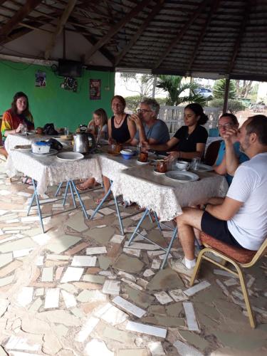 um grupo de pessoas sentadas à volta de uma mesa em Abuesi Beach Resort em Takoradi