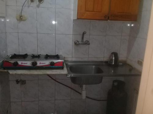 a kitchen with a sink and a stove at Flat for rent in Sharm El Sheikh