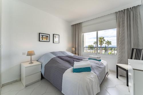 a bedroom with a bed and a desk and a window at Apartment in Miraflores in Mijas Costa