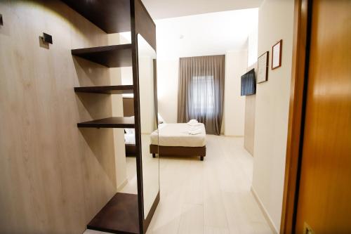 a room with a mirror and a bedroom with a bed at Hotel Diplomatic in Turin
