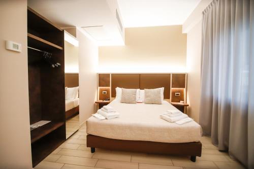 a bedroom with a bed with towels on it at Hotel Diplomatic in Turin