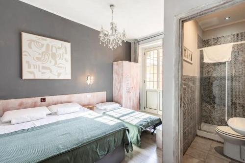 a bedroom with a bed and a bathroom at Domus Ferruccio in Rome