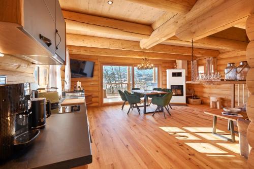 a kitchen and dining room of a log cabin at Lederer Chalets in Bodenmais