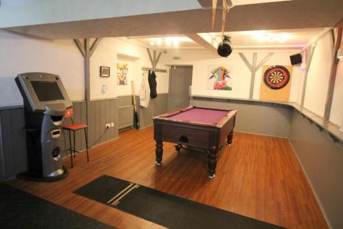 a room with a ping pong table and a video game at The Gordon Arms Hotel in Huntly