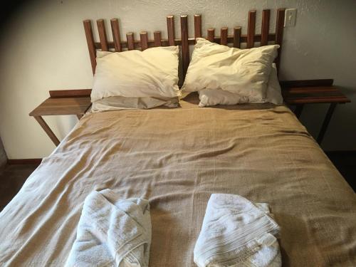 a large bed with white sheets and pillows at Elviajero in Campinas