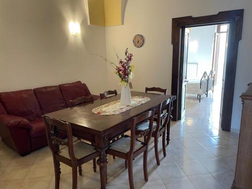 a living room with a table and a couch at Casetta Parini in Porto Cesareo