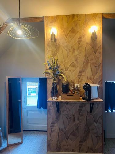 a room with a table with flowers on a wall at B&B Het Molenhuisje Winschoten - met woonkamer & keuken in Winschoten
