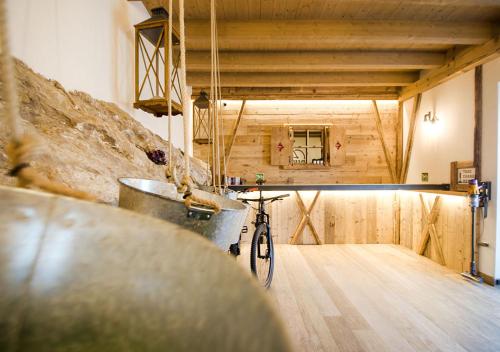 a bike parked in a room with a wooden wall at Casa Tosca - Holiday Home in Nago-Torbole