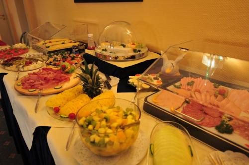 a buffet with many different types of food on a table at Hotel Allegro in Cologne