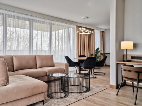 a living room with a couch and a table at AC Hotel by Marriott Krakow in Kraków