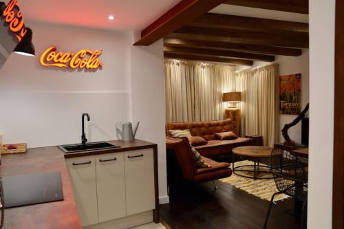 a kitchen and a living room with a couch at Can Senio 2 in Tossa de Mar