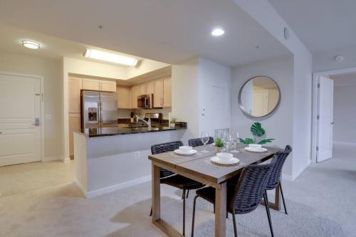a kitchen and dining room with a table and chairs at Bright and Cozy Apartment Near Pentagon City in Arlington