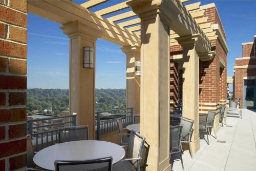 a patio with tables and chairs on a balcony at Bright and Cozy Apartment Near Pentagon City in Arlington