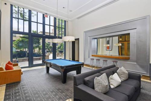 a living room with a couch and a pool table at Bright and Cozy Apartment Near Pentagon City in Arlington