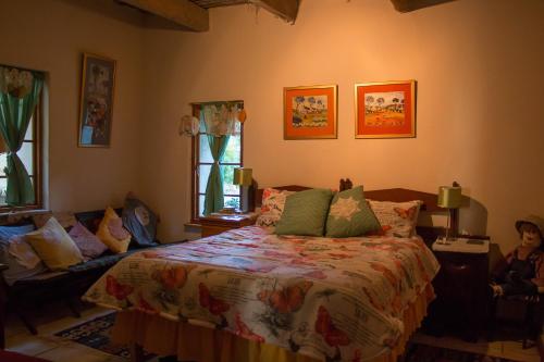 a bedroom with a bed in a room with windows at Waterval farmstay in Graaff-Reinet